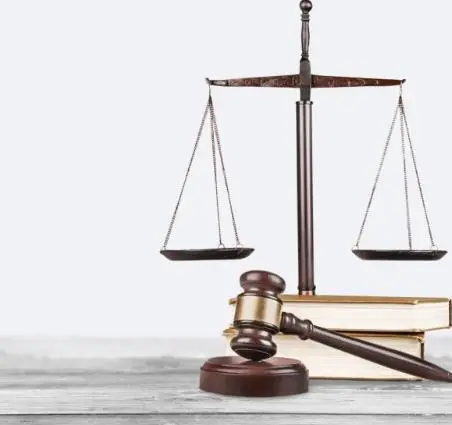 Scales of justice and gavel on law books